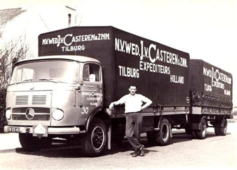 An Old Photo Of A Man Standing Next To A Truck With Advertising On The Side