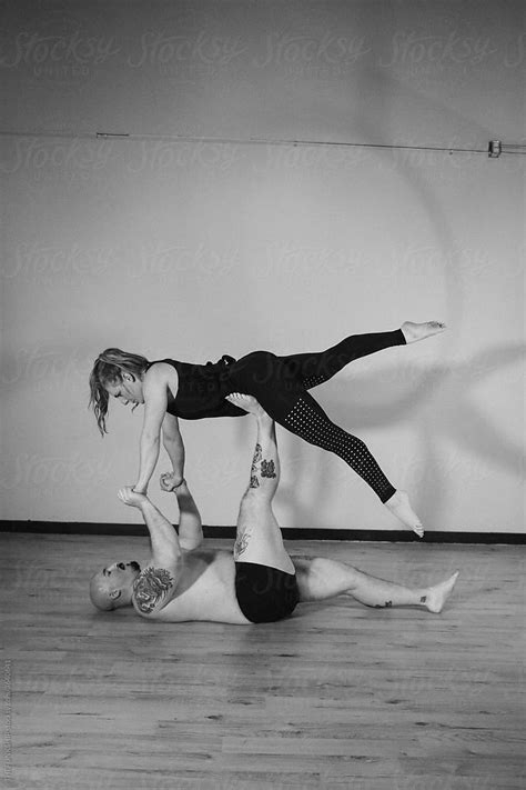 fit couple doing acro yoga stock image everypixel