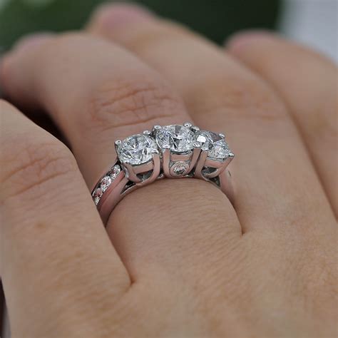 Dazzling Three Stone Engagement Ring Features 300ct Of Round Cut