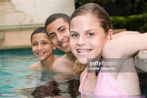 Brother And Sister Swimming Underwater In Swimming Pool Photos And