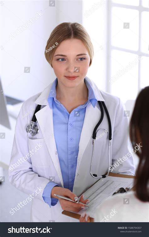 Go to question 4a females only. Young woman doctor and patient at medical examination at ...