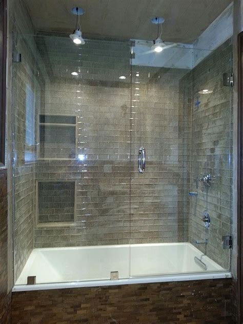A glass bathtub enclosure can make a small bathroom appear more spacious and airy. Frameless glass shower and tub enclosure near Atlanta ...