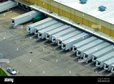 Top view of giant logistics center with many commercial trailer trucks