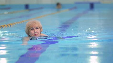 Senior Woman Swims In Blue Swimming Pool Stock Video Footage Storyblocks