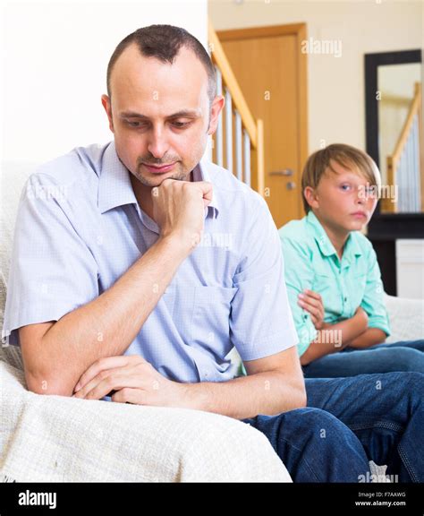 Portrait Tired Father And Frustrated Young Son Having Quarrel At Home