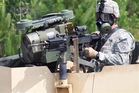 A Paratrooper Aims His M249 Machine Gun From The Gunners Turret On A