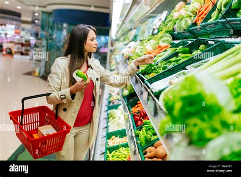 Beautiful Women Shopping Vegetables And Fruits In Supermarket Stock