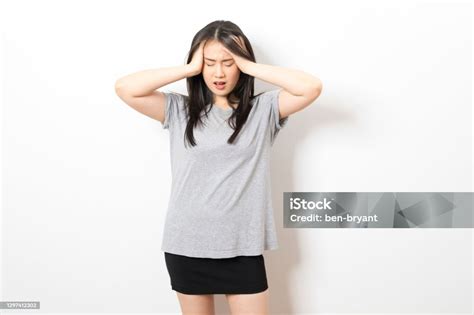Young Asian Woman Suffer From Stress And Headaches On A White