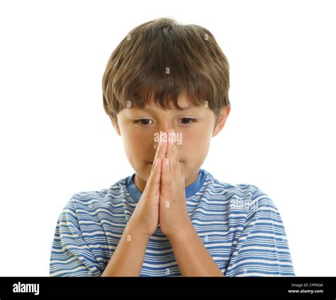 Young Boy Looking Upwards With Hands Together Praying Or Waiting In