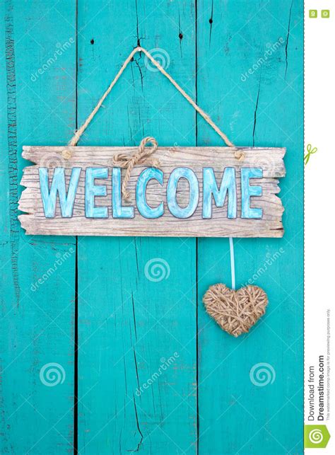 Wood Welcome Sign With Heart Hanging On Painted Door Stock Image