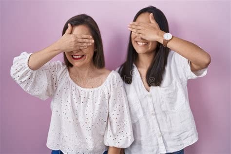 Hispanic Mother And Daughter Together Smiling And Laughing With Hand On