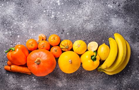 Premium Photo Assortment Of Yellow And Orange Fruits And Vegetables