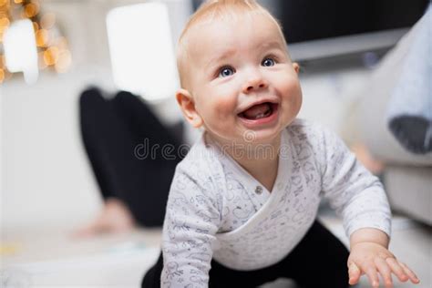 Cute Infant Baby Boy Playing Crawling And Standing Up By Living Room
