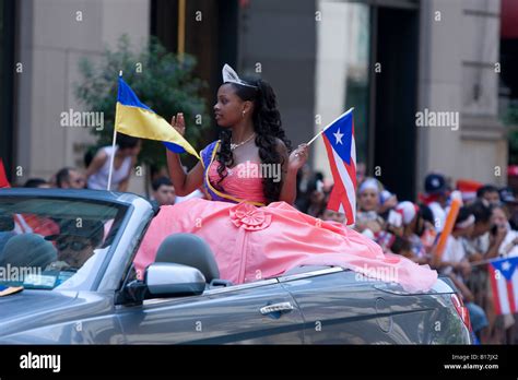a puerto rican girl waves to onlookers at the puerto rican day parade in new york city stock