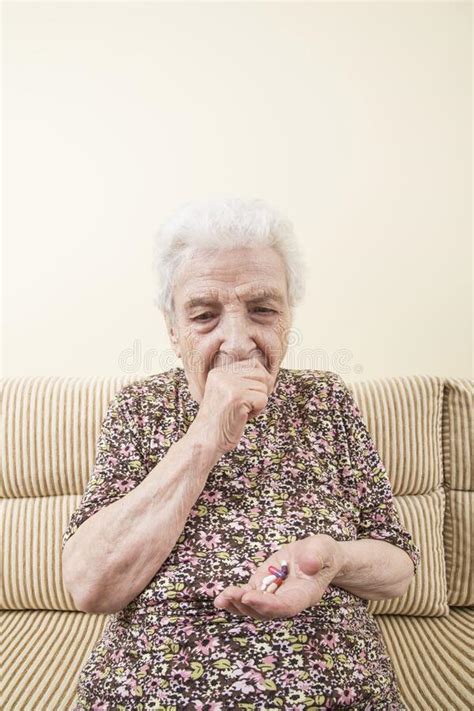 Old Woman Coughing While Holding Pills On Her Palm Stock Photo Image