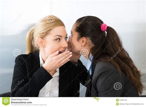 Businesswoman Whispering To Colleague Stock Image - Image of girl ...