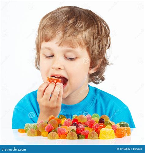 Little Boy Eating Jelly Candies On White Background Stock Photo Image