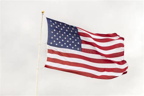 An American Flag Waving On A Cloudy Windy Day Stock Photo Image Of