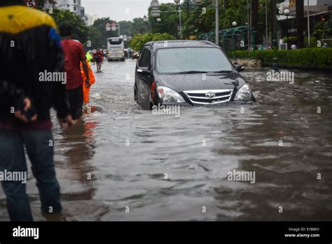 A Car Moving Through A Flooded Street After A Continuous Rain Left The