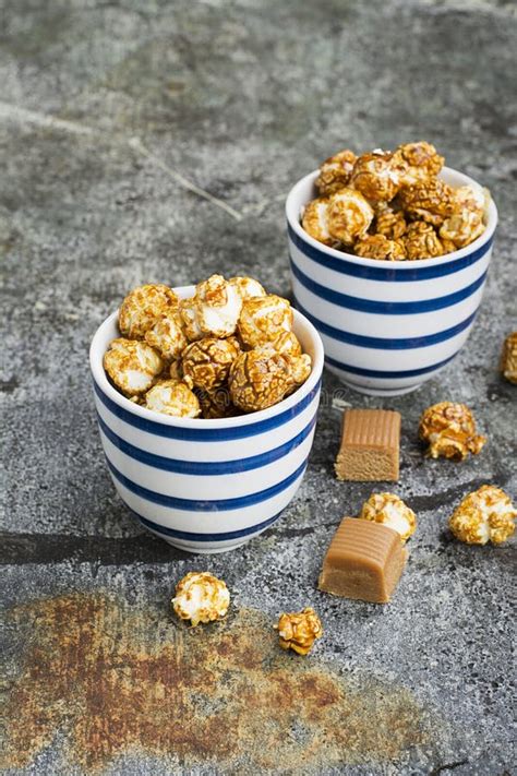 Sweet Caramel Popcorn In Two Ceramic White Striped Blue Bowls On A