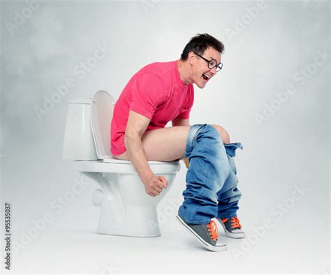 Man With Glasses Straining On The Toilet The Concept Of Situation Stock Photo And Royalty