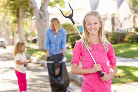 Mother And Daughters Picking Up Litter In Suburban Street Stock Image Colourbox