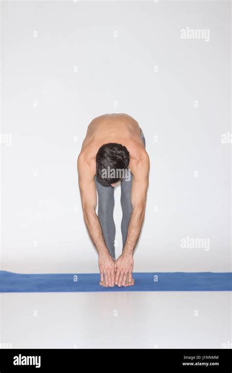 Young Man Stretching Touching Toes Flexible Studio White Background
