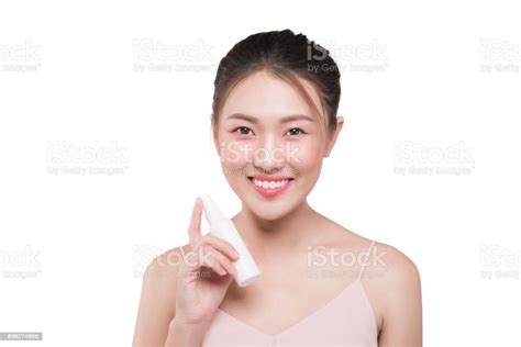 Beautiful Model Showing Applying Cosmetic Cream Treatment On Her Face