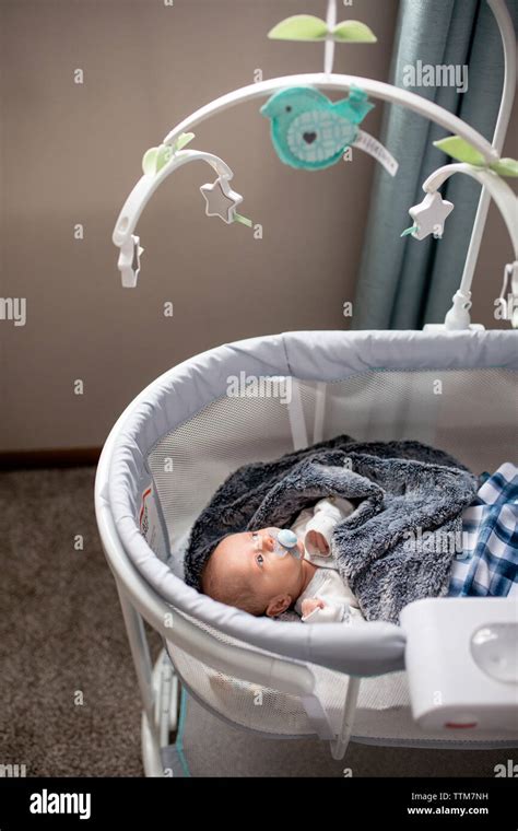 Baby Lying In Crib Looking At Mobile Hi Res Stock Photography And