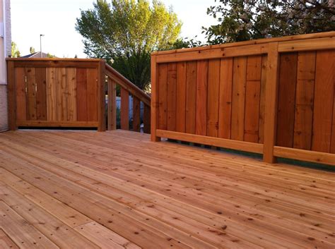A bench is a perfect deck hand railing idea since it gives a natural place to congregate. Stained Cedar Deck with Fenced Railing | Deck railings, Deck with pergola, Cedar deck