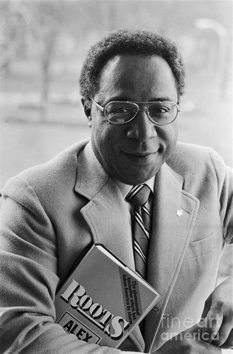 Alex Haley Carrying A Copy Of Roots By Bettmann