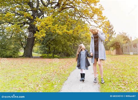Mother And Daughter Walking Holding Hands At Park Stock Photo Image