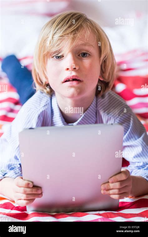 7 Year Old Boy Using Tablet Computer Stock Photo Alamy