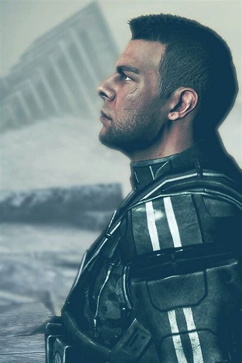 A Man In A Futuristic Suit Looks Off Into The Distance With His Head