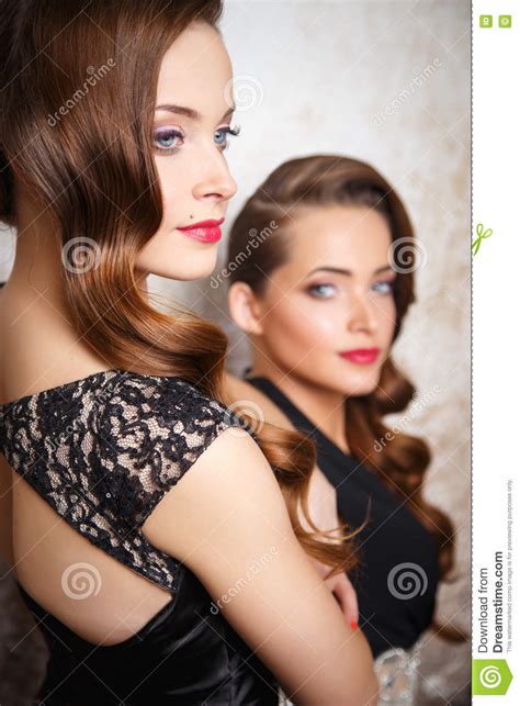 Portrait Of Beautiful Twins Young Women In Gorgeous Evening Dresses