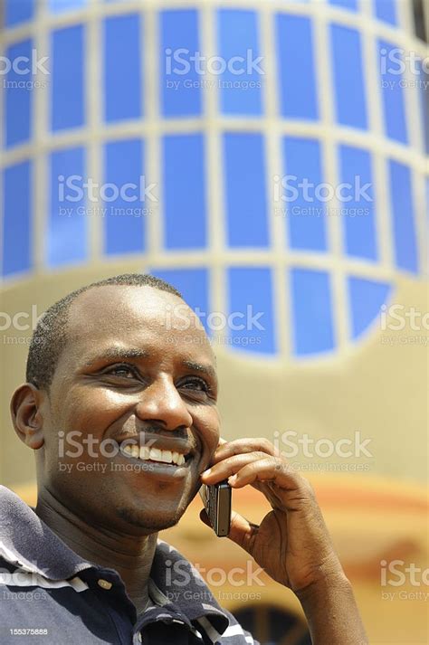 Smiling Central African Male Using Mobile Phone Stock Photo Download
