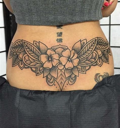 45 hottest meaningful lower back tattoos for women