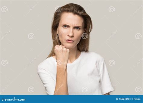 Angry Young Woman Showing Clenched Fist At Camera Warning Stock Image