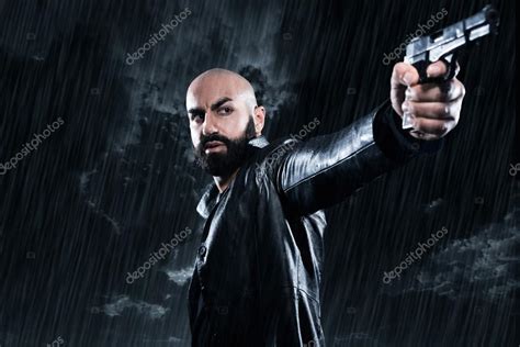 Maybe you would like to learn more about one of these? Dangerous bald gangster man with beard holding gun ...