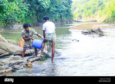 Tribal Fishermen Catch Fish With Fishing Nets In The Creek Tribals