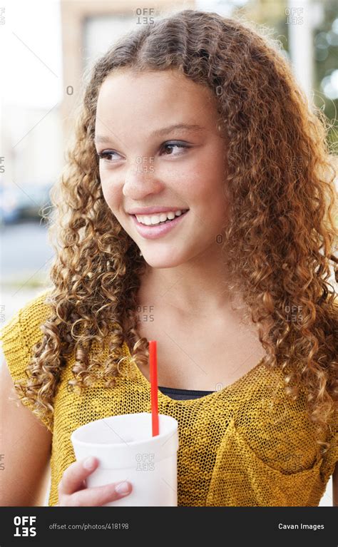 Teenage Girl Looking Away While Holding Disposable Cup