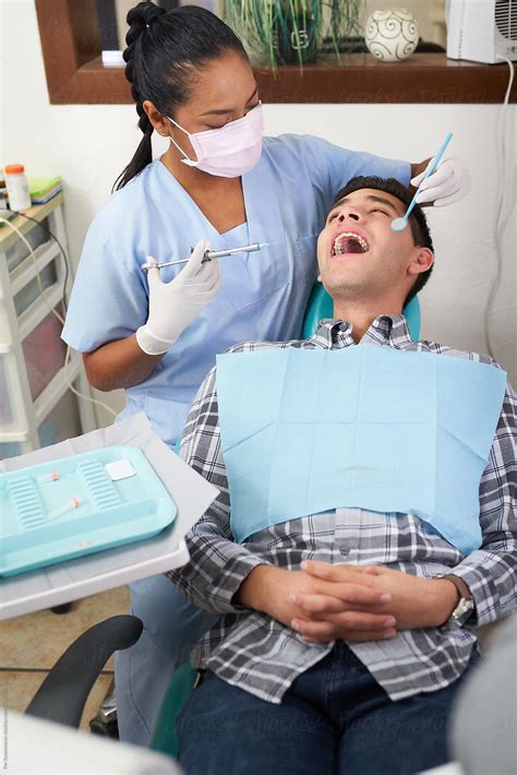 Dentist Preparing A Treatment On A Patient by PER Images