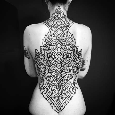 The Back Of A Woman S Body Is Covered In Intricate Tattoo Designs And Tattoos