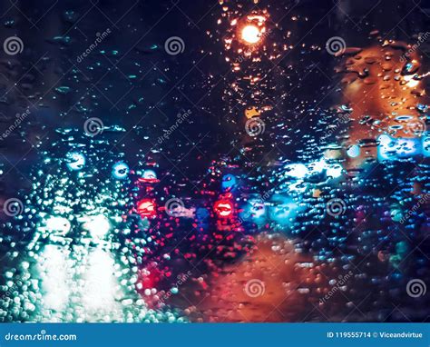 Blurred Light Traffic Lights Bokeh With Rain Drops On Glass Stock Photo