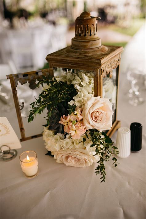 Lantern centerpiece with roses and hydrangea. Design/floral by La