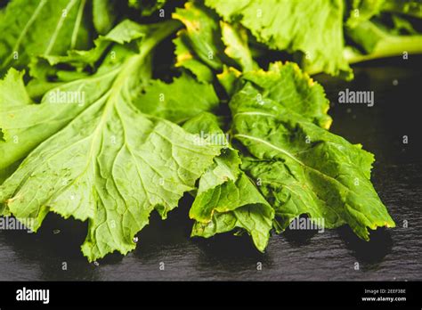 Turnip Greens Leaves On Reflective Black Slate Stock Photo Alamy