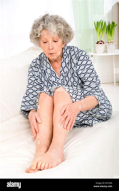 MODEL RELEASED Senior Woman Touching Her Legs Stock Photo Alamy