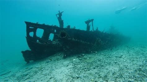 Premium Ai Image A Shipwreck Is Partially Submerged In The Ocean