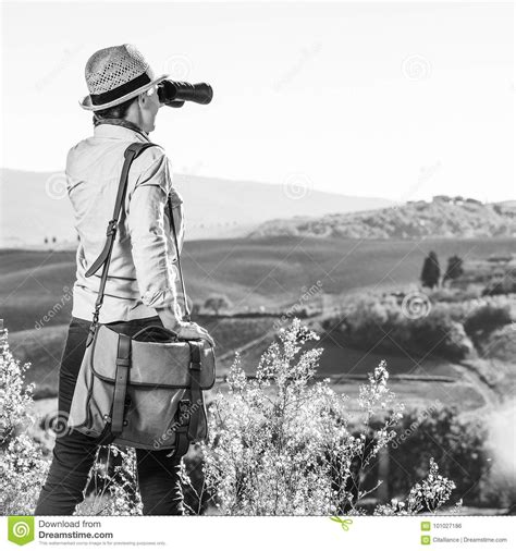 Woman Hiker In Tuscany Looking Into Distance Through Binoculars Stock