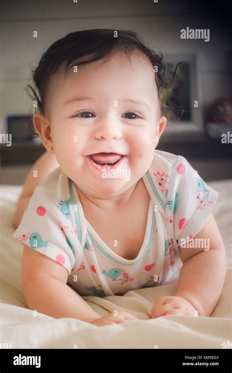 Portrait Of A Smiling Baby Girl Lying On Her Front Stock Photo Alamy